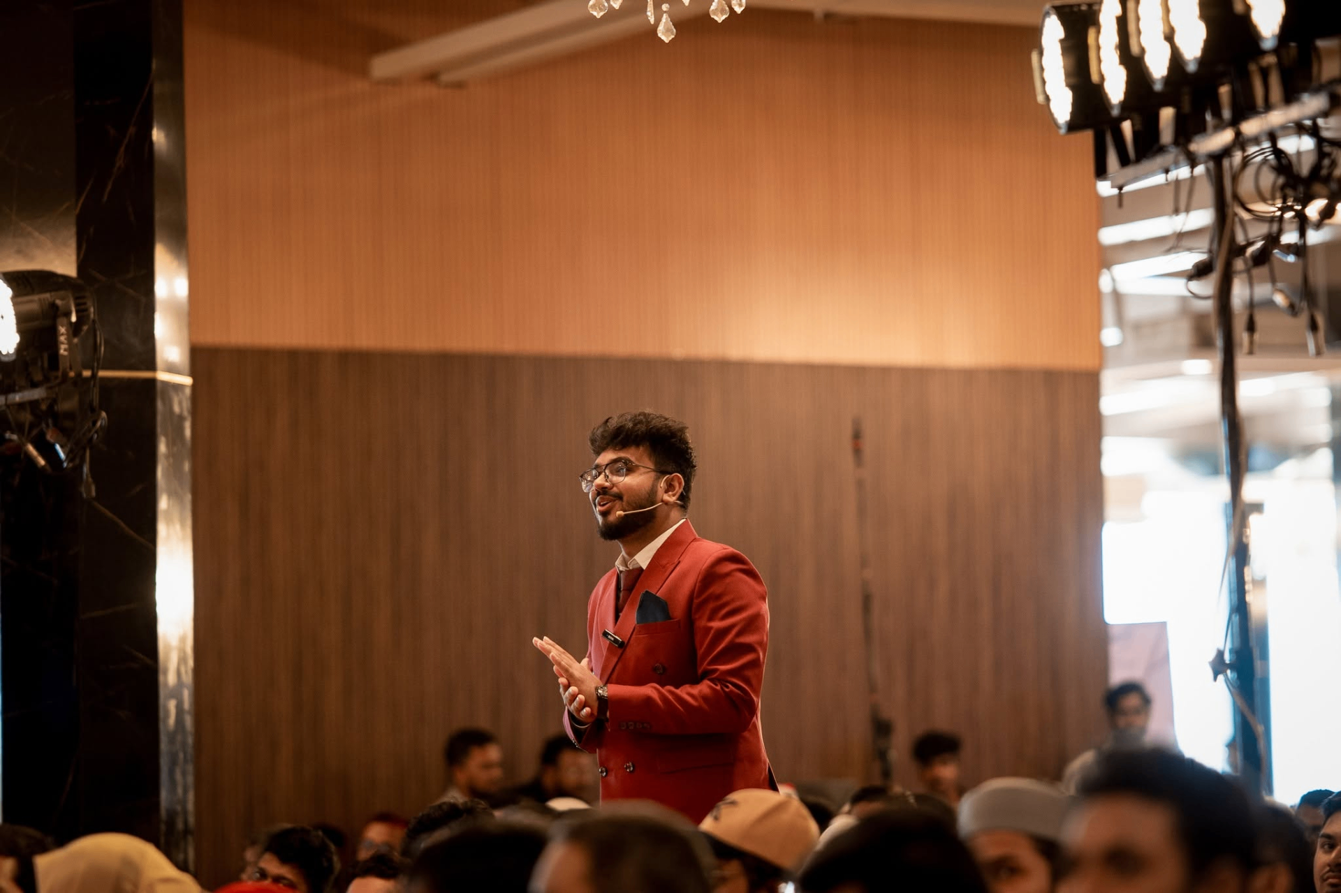 Nerob Pikash speaking on stage at a professional event