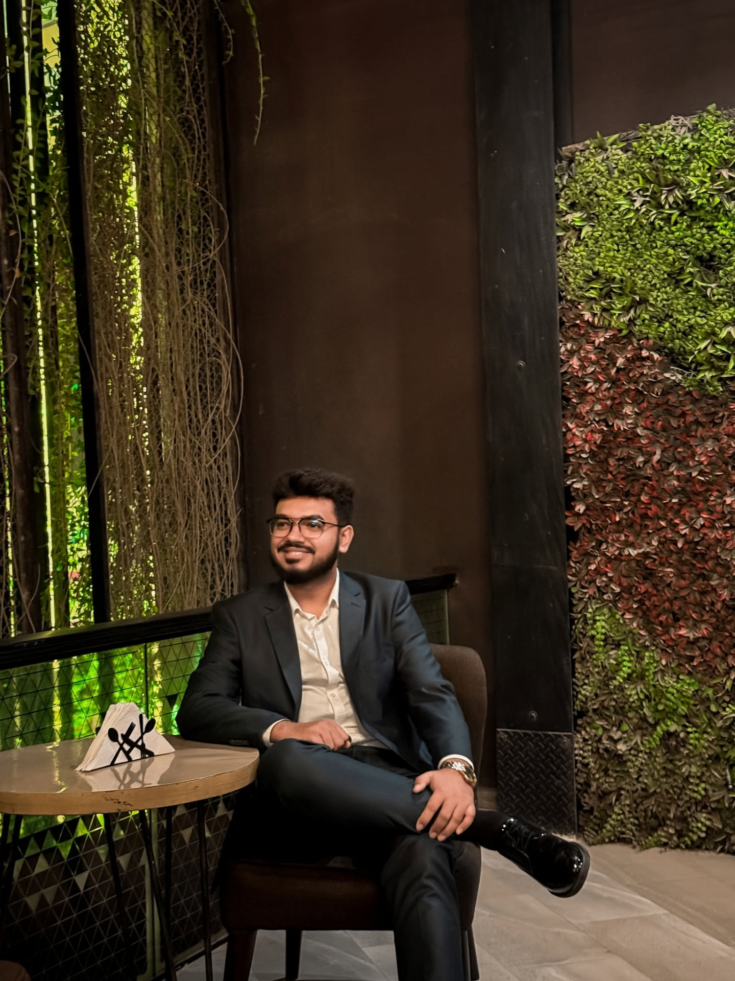 Nerob Pikash seated in a lounge in formal business attire